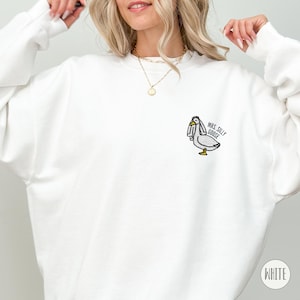 May include: White sweatshirt with a cartoon goose wearing a veil and the text "Mrs. Silly Goose" embroidered on the front.