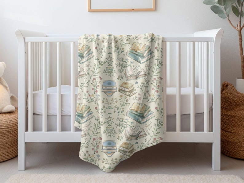 May include: A white crib with a cream and green baby blanket featuring a pattern of stacked books and floral sprigs.