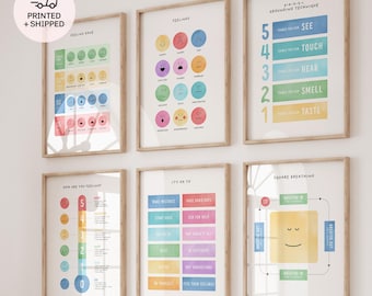 May include: A set of six colorful educational posters for children, featuring illustrations of emotions, senses, and a happy face. The posters are framed and hung on a white wall in a nursery or playroom.