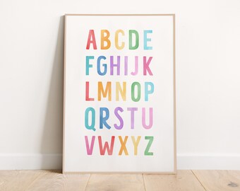 May include: A framed print featuring the alphabet in uppercase letters. Each letter is a different color, including red, orange, yellow, green, blue, and purple. The print is displayed on a white background and has a wooden frame.