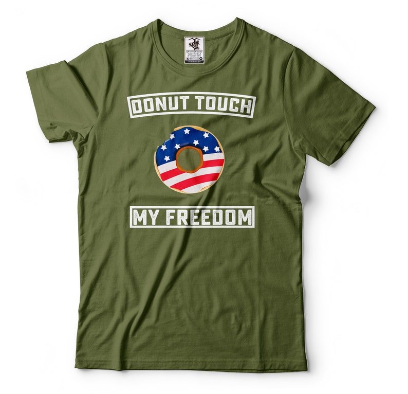 May include: A green t-shirt with the text "Donut Touch My Freedom" in white. A donut with an American flag design is in the center of the shirt.