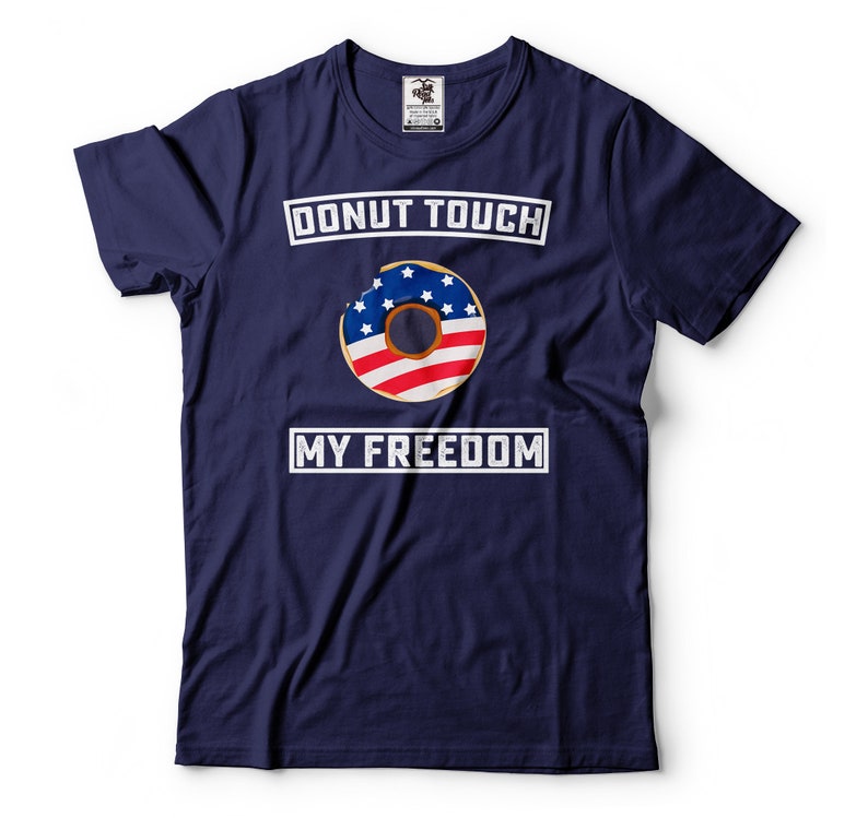 May include: A navy blue t-shirt with a white graphic of a donut with the American flag design. The text "DONUT TOUCH MY FREEDOM" is printed in white on the shirt.