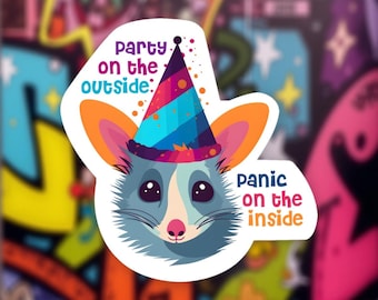 May include: A sticker featuring a cartoon opossum wearing a party hat. The opossum has blue-gray fur, large eyes, and orange ears. Text on the sticker reads "Party on the outside: panic on the inside."