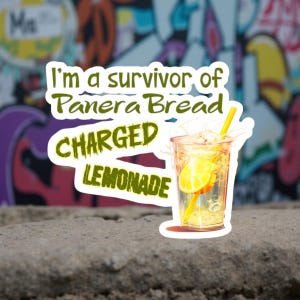 May include: A sticker featuring a clear glass of charged lemonade with a yellow straw and lemon slices. The text reads "I'm a survivor of Panera Bread CHARGED LEMONADE" in green and yellow.