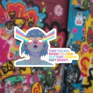 May include: A sticker featuring an illustration of a person with blue hair and glowing eyes, with a rainbow beam emanating from each eye. The sticker includes the text: "THAT FEELING WHEN YOU FIND OUT THAT GENDER ISN'T BINARY..."