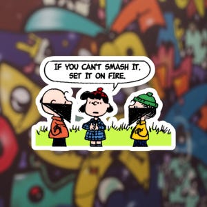 May include: A sticker featuring three cartoon characters wearing face coverings, with the text "IF YOU CAN'T SMASH IT, SET IT ON FIRE." The characters are standing on grass, with a colorful graffiti background.