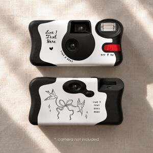 May include: Two white and black disposable camera covers featuring custom text areas. The top cover displays Line 1 Text Here, a heart icon, and Line 2 Here. The bottom cover shows a line art illustration of two birds holding a ribbon and Line 3 Text Goes Here.