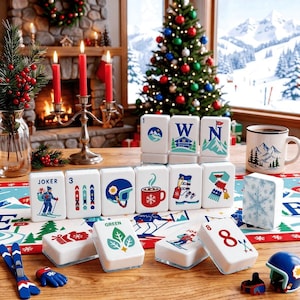 May include: A set of white rectangular tiles featuring winter-themed illustrations including a skier, skis, a helmet, a mug, a scarf, and snowflakes. Some tiles display the text JOKER, GREEN, or the number 8, arranged on a festive table runner.
