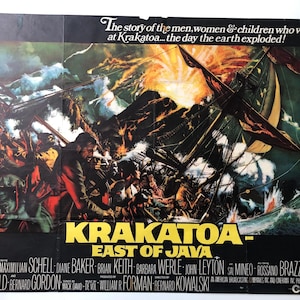 May include: A movie poster for the film "Krakatoa, East of Java" depicting a dramatic scene of a ship caught in a storm with a volcanic eruption in the background. The poster includes the film's title, the tagline "The story of the men, women & children who were at Krakatoa... the day the earth exploded!" and the names of the actors in the film.
