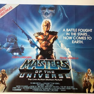 May include: A movie poster for the film "Masters of the Universe", featuring a muscular man in a loincloth and a horned helmet, holding a sword. The poster has a blue and black background with the text "Coming this Christmas" in the top left corner and "A battle fought in the stars... Now comes to Earth." in the top right corner.