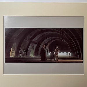 May include: A vintage Star Wars illustration depicting a scene from the movie. The image shows three characters in a dark, arched hallway. The characters are a robed figure, a droid, and a humanoid figure. The robed figure is standing in the center of the image, with the droid and humanoid figure to the right. The hallway is dark and shadowy, with the only light coming from the characters themselves.