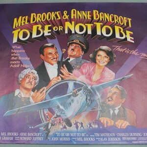 May include: A vintage movie poster for the film "To Be or Not to Be" starring Mel Brooks and Anne Bancroft. The poster features a purple background with a plane flying through the center. The text "That is the movie!" is written in white on the right side of the poster.