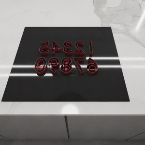 May include: A black surface with red numbers 6, 7, 8, 9, 0, 1, 2, 3, 4, and 5.
