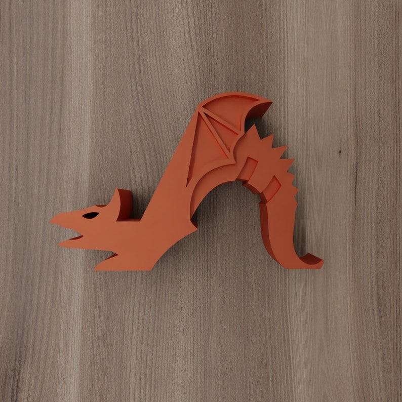May include: Orange dragon figurine with wings outstretched and a curled tail. The dragon is made of a smooth, solid material and has a stylised design.