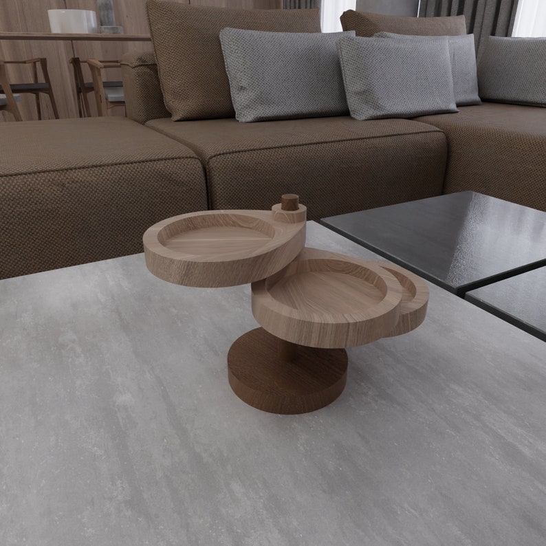 May include: A wooden two-tiered serving tray with a round top and a smaller round bottom. The tray is made of light brown wood and has a natural finish.