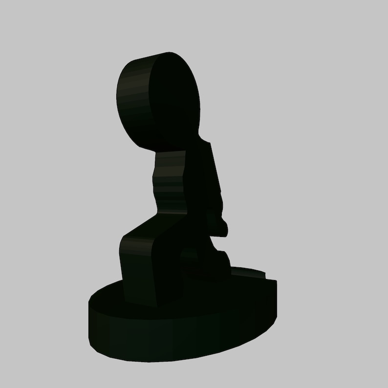 May include: Black ceramic figurine of a person sitting with their legs crossed. The figurine is stylised and abstract.