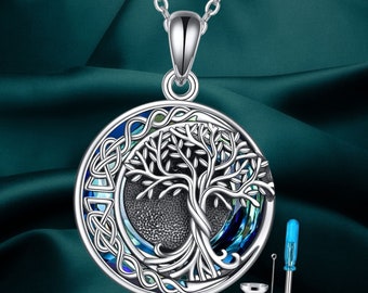 May include: Silver necklace with a round pendant featuring a tree of life design with blue and green iridescent stones. The pendant is attached to a silver chain. The necklace comes with a small funnel and a screwdriver.
