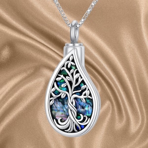 Może przedstawiać: Srebrny naszyjnik z wisiorem w kształcie łzy z motywem drzewa życia. Wisiorek zdobi intarsja z niebieskiego i zielonego abalonu.
