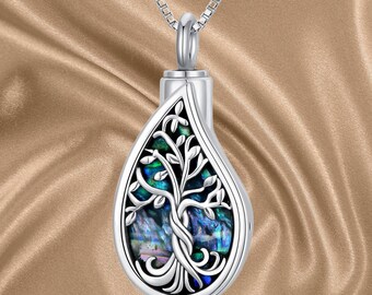 May include: Silver teardrop-shaped pendant necklace with a tree of life design. The pendant features a blue and green abalone shell inlay.