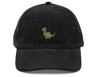 May include: A black corduroy baseball cap with an embroidered green dinosaur on the front.