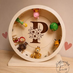 May include: A wooden, circular display shelf with a large letter "P" and floral design. The shelf contains various small toy figurines, including a giraffe, pig, and other characters. The shelf is on a wooden base.