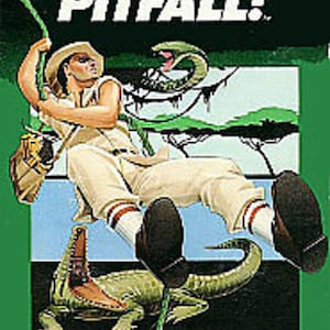 May include: A vintage video game cartridge for the Intellivision console. The game is called "Pitfall!" and features a green jungle scene with a man swinging on a vine, a snake, and an alligator. The text "Activision" is printed in white on a black background.