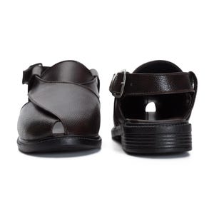 May include: A pair of brown leather sandals with a buckle closure. The sandals have a closed toe and an open heel.