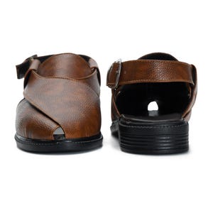 May include: A pair of brown leather sandals with a buckle closure. The sandals have a black rubber sole.