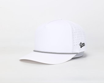 May include: White baseball cap with a curved brim and a black and white rope detail. The cap features a perforated side panel and a small black logo on the side. The hat is designed for sun protection and casual wear.