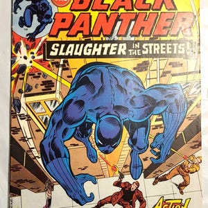 Op de afbeelding: Een vintage Jungle Action stripboek, nummer 20, met The Black Panther op de cover. Het artwork toont het personage in een blauw pak dat over figuren in een straatscène springt. De titel luidt Slaughter in the Streets.