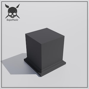 May include: A black square pedestal with a raised base. The pedestal is made of a smooth, matt material.
