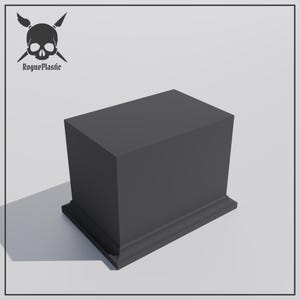 May include: A dark grey rectangular display stand with a decorative base. The stand is made of a solid material, suitable for showcasing products. The RoguePlastic logo, featuring a skull and crossbones, is in the upper left corner.