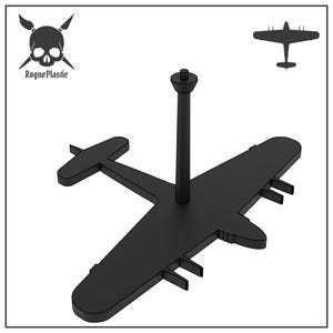 May include: Black airplane-shaped display stand with a vertical support post. The stand has a skull and crossbones logo with the text "Rogue Plastic" in the upper left corner. A silhouette of an airplane is in the upper right corner.