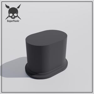 May include: A matte black, solid, oval-shaped display base with a raised platform and a flat top surface. In the upper left corner, a logo features a skull with two crossed knives and the text RoguePlastic written in a black gothic font.