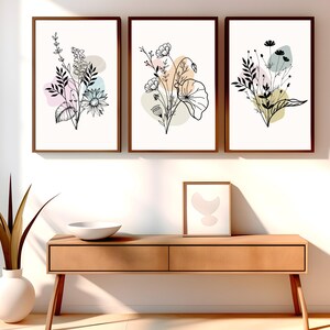 May include: Three framed prints with black and white line drawings of floral bouquets. Each print features a different bouquet with pastel colored abstract shapes behind the flowers.