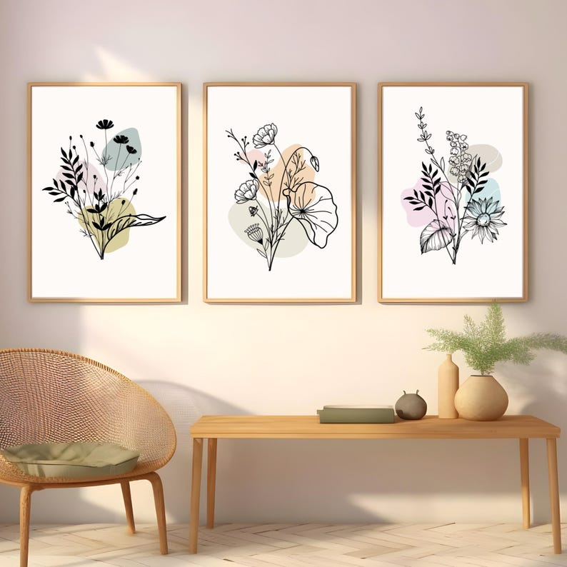 May include: Three framed prints with black line drawings of floral bouquets on a white background. Each print features a different bouquet with pastel colored abstract shapes behind them.