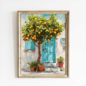 May include: Framed print depicting an orange tree with ripe fruit, set before a white building with a turquoise door and shutters. The artwork includes potted plants and a house number.