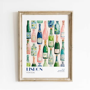 May include: A framed print featuring a collection of illustrated champagne and wine bottles in various colors, including pink, green, and blue. The word "LISBON" is printed in blue, with "PORTUGAL" below it. The print is part of the "GALLERY D'ART PRINT COLLECTION".