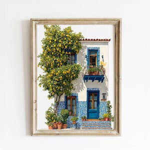 May include: Framed print of a Mediterranean-style house with a lemon tree. The house features blue accents, a balcony, and a blue door. The tree is laden with yellow lemons, and potted plants are placed around the entrance.