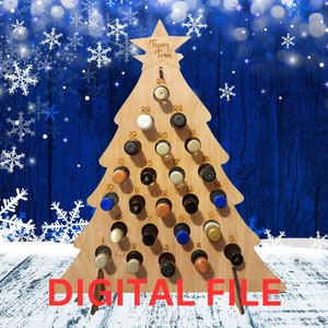 May include: A wooden Christmas tree shaped bottle holder with 24 numbered slots for small bottles. The tree is standing on a white surface with a blue and white snowflake background. The text "Tipsy Tree" is printed on the top of the tree.