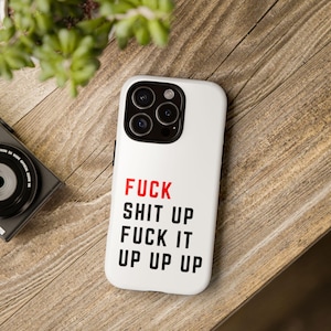 white iphone 17 tough case with print fuck shit up fuck it up up up, laying on a swifty desk
