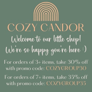 May include: A graphic with the text "COZY CANDOR" and "Welcome to our little shop! We're so happy you're here :)". The image also includes information about discounts with promo codes for orders of 3+ and 7+ items.