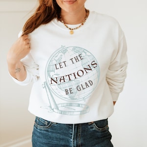 May include: White sweatshirt with a blue globe graphic and the text "Let the Nations Be Glad".