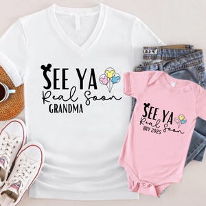 May include: A white t-shirt with a black Mickey Mouse head and the text "See Ya Real Soon Grandma". A pink baby onesie with the text "See Ya Real Soon July 2025" and a Mickey Mouse head.