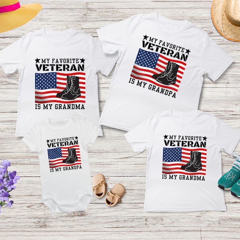 May include: Three white t-shirts featuring an American flag and boots design. The text on the shirts reads "My Favourite Veteran is My Grandma" and "My Favourite Veteran is My Grandpa".