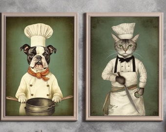 May include: Two framed prints of a dog and a cat dressed as chefs. The dog is wearing a white chef's hat and a red bandana. The cat is wearing a white chef's hat and a black bow tie. Both animals are holding kitchen utensils.