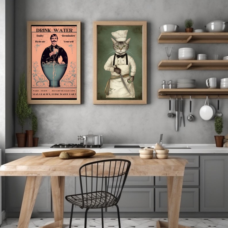 May include: Two framed prints in a kitchen setting. The print on the left features a man in a suit holding a glass of water with the text "Drink Water - Daily Hydrate - Reminder Yourself - Stay Healthy, Live Well, Drink Water Early". The print on the right features a cat dressed as a chef holding a knife with a green background.