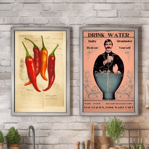 May include: Two framed prints. One features four red chili peppers with green stems on aged paper. The other print has a vintage design with the text "DRINK WATER" and an illustration of a man pouring water.