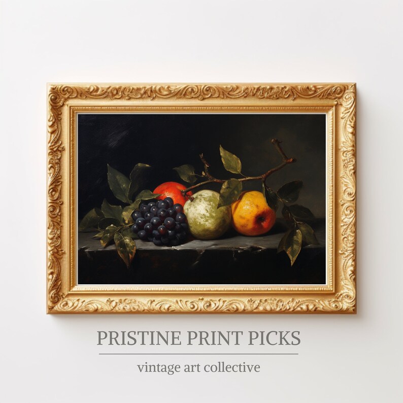 May include: A framed still life painting featuring a cluster of dark grapes, a red apple, and two pears in shades of green and yellow. The artwork is set against a dark background and framed in a gold ornate frame. The text "PRISTINE PRINT PICKS" and "vintage art collective" are at the bottom.