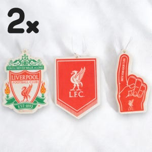 May include: Two Liverpool Football Club car air fresheners. One is a red shield with the team's crest and the words "L.F.C." and "You'll Never Walk Alone". The other is a red foam hand with the team's crest and the words "L.F.C." and "You'll Never Walk Alone".